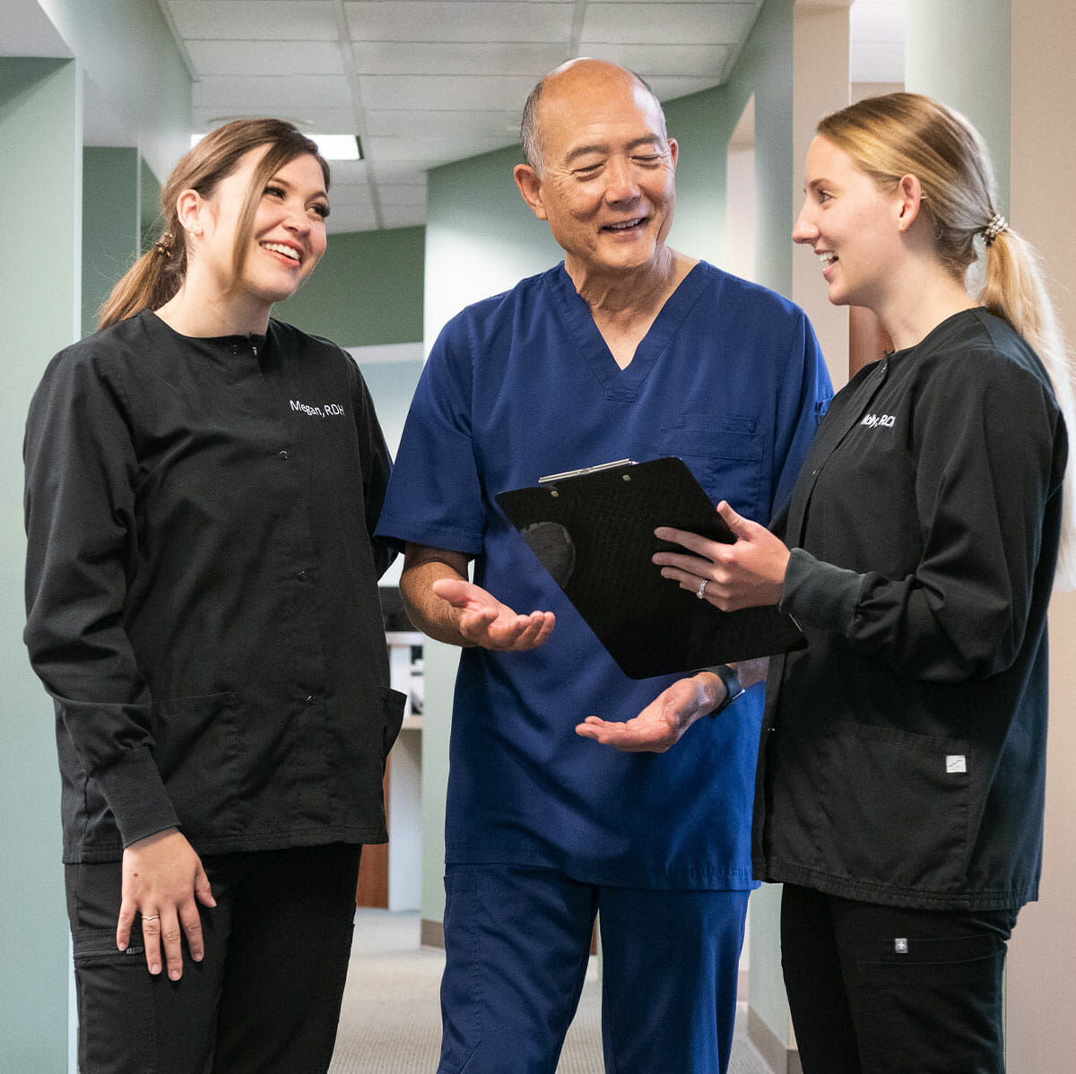 Dr. Sato and team members talking in hallway