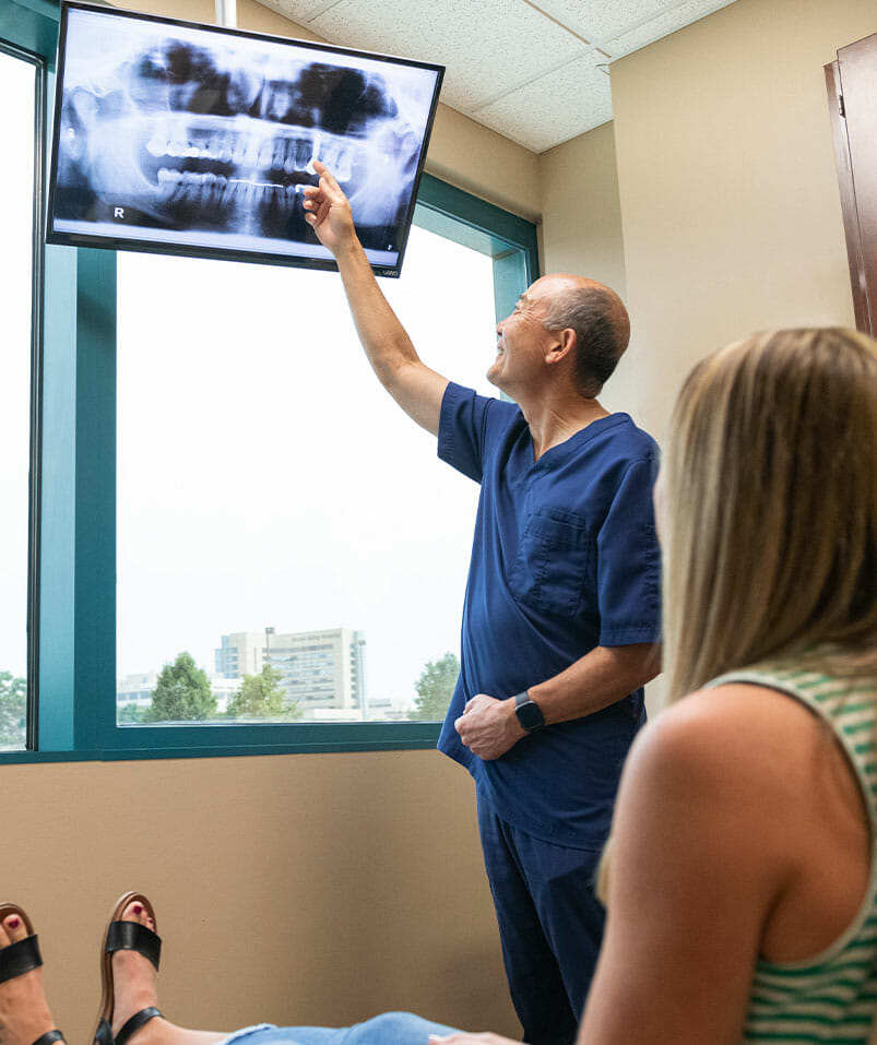 Dr. Sato showing patient dental x-rays